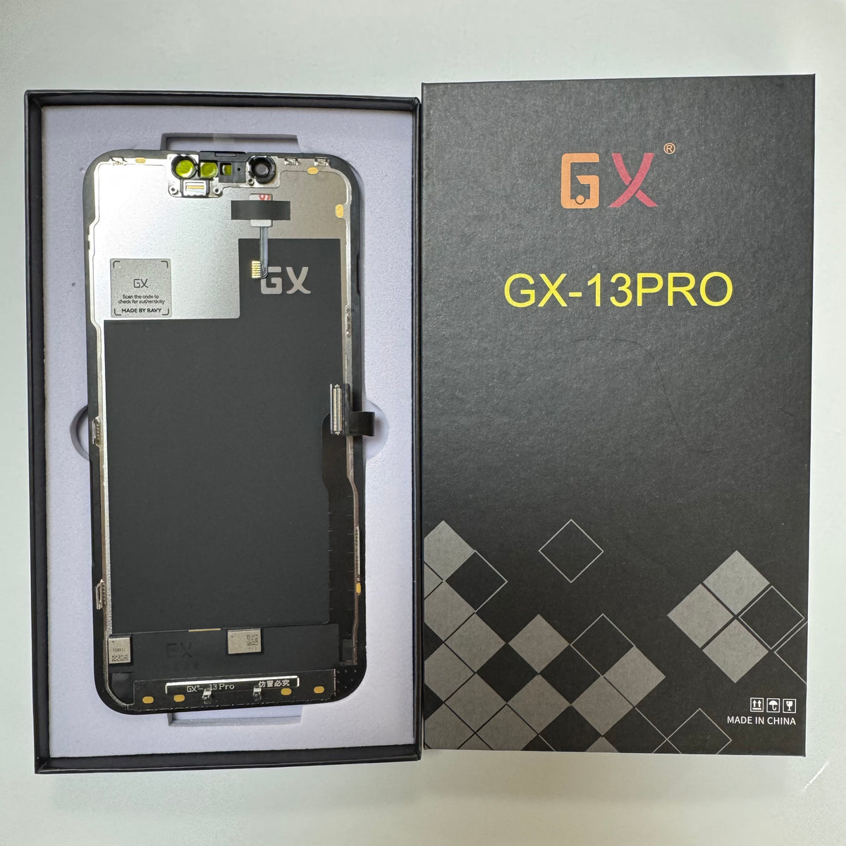 Hard OLED screen for iPhone 13 Pro in its tray, beside its labelled box